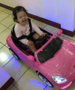 Moderno Kids Kiddie Roadster 12V Power Children Ride-On Car with R/C Parental Remote + Leather Seat 5 Point Seat Belt + LED Wheels + MP3 USB Music Player + Baby Tray Table + Rubber Floor Mats (Pink) Pink 70 71NVlKpUaCL