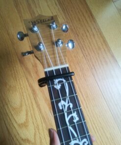 D'Addario Accessories Ukulele Pro Capo - For Soprano, Concert, Tenor, Baritone Ukuleles - 4 String Ukulele Capo - Micrometer Tension Adjustment for Buzz-Free, In-Tune Performance - Black 1 Pack 33 816pz9cjw9L