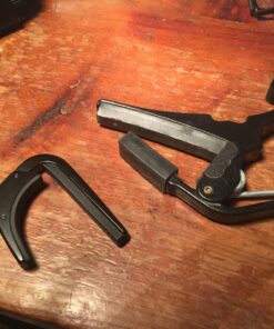 D'Addario Accessories Ukulele Pro Capo - For Soprano, Concert, Tenor, Baritone Ukuleles - 4 String Ukulele Capo - Micrometer Tension Adjustment for Buzz-Free, In-Tune Performance - Black 1 Pack 43 81fxyxWkQSL