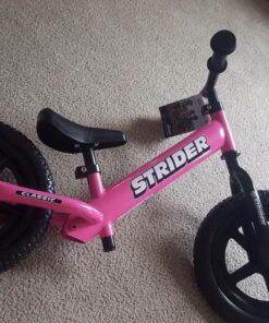 Strider 12” Classic Bike - No Pedal Balance Bicycle for Kids 18 Months to 3 Years - Includes Built-In Footrest, Handlebar Grips & Flat-Free Tires Pink 35 81jjbJ4ymgL